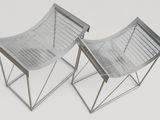 pair of chromed steel chairs on a white background