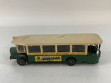 a close up of a toy bus on a white surface