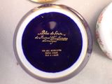 a blue plate with a gold rim and a white plate with a gold rim
