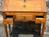 an image of a wooden desk with two drawers and a clock on it