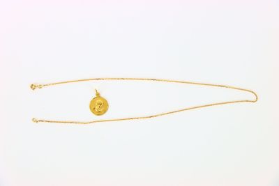 an image of a gold necklace with a coin on it