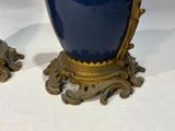 two vases that are sitting on a table