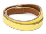 a close up of a yellow and brown leather bracelet on a white background