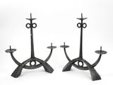 pair of iron candlesticks in the shape of an eye