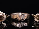 three rings and a ring with flowers on a black surface