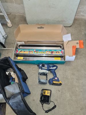 a box of tools sitting on the floor next to a box of tools