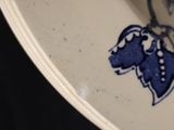 a blue and white plate with a dog design on it