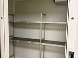 an open door to a closet with shelves in it