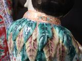 a figurine of a woman sitting on top of a table