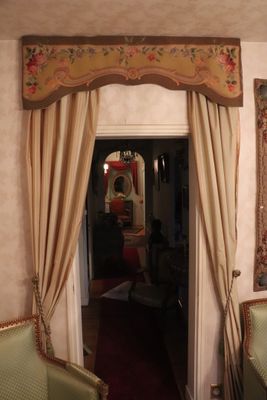 a doorway leading to a living room with a couch and a chair