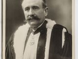 an old black and white photo of a man in a robe