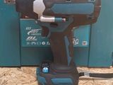 a drill that is sitting on the floor next to a box