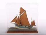 a small model of a sailboat in a glass case