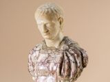 a marble bust of a man on a pedestal