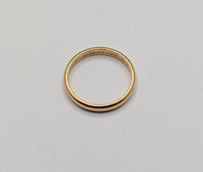 a close up of a gold ring on a white surface
