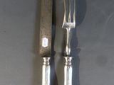 two forks and a knife sitting on a table