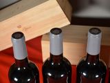 four bottles of wine are lined up in a row on a table