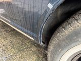 a close up of a car with a tire on the ground
