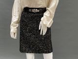an image of a mannequin wearing a black and white skirt and blouse