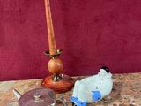 a table with a candle, a teapot, and other items on it