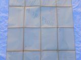 a sheet of clear glass on a blue sheet of plastic