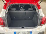 the back of a white car with its trunk open in a parking lot