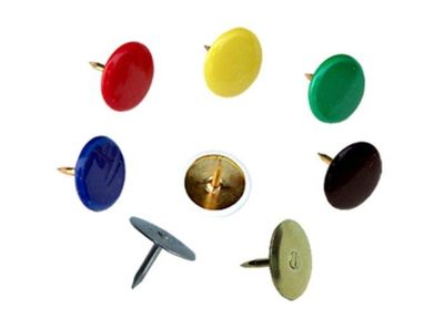 many different colors of screws on a white surface