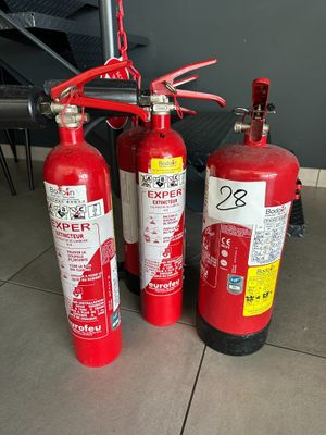 three fire extinguisors sitting on the floor next to each other