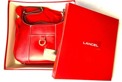 a red box with a red purse inside of it