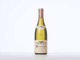 a bottle of white wine sitting on top of a table