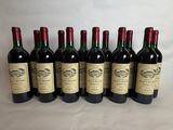 six bottles of red wine lined up in a row