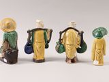 three figurines of asian people with hats and carrying bags