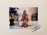 a picture of a woman in a kimono sitting on a couch