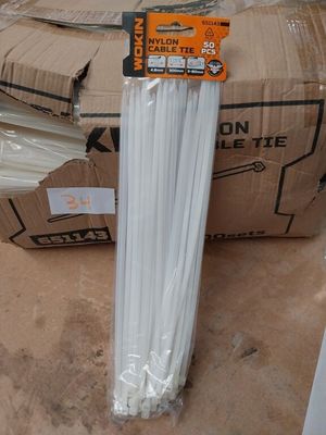 a cardboard box with a bunch of white plastic straws in it