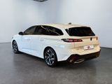the rear end of a white car in a white room
