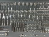 a lot of silver spoons and forks on the table