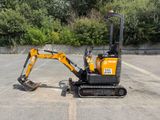 a small excavator that is parked in a parking lot
