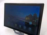 a tablet that is sitting on a stand on a table
