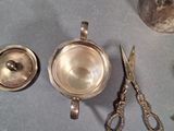 a silver tea pot and a silver tea set on a table