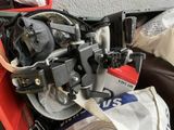 a close up of a motorcycle engine with a hose attached to it