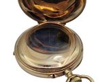 a gold pocket watch with a keychain on a white background