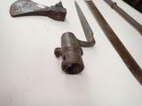 several old tools are displayed on a table in a museum