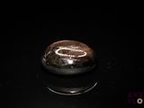 an image of a black and silver object on a black surface