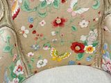 a close up of a chair with a floral pattern on it