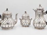 three pieces of silver tea and coffee set on a white background