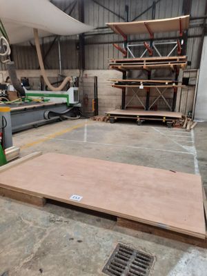 a large wooden floor in a building with a lot of wood on it