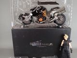 a figurine of a motorcycle and a motorcycle in a display case