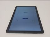 the tablet is sitting on a table with a blue screen