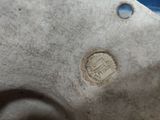 a close up of a piece of pottery with a hole in it