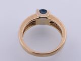 a close up of a gold ring with a sapphire stone
